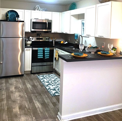 a kitchen with stainless steel appliances and white cabinets